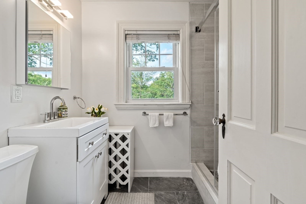 77 Meriam Street Lexington, MA 02420 - Photo 22 of 35 a bathroom with a sink a toilet and window