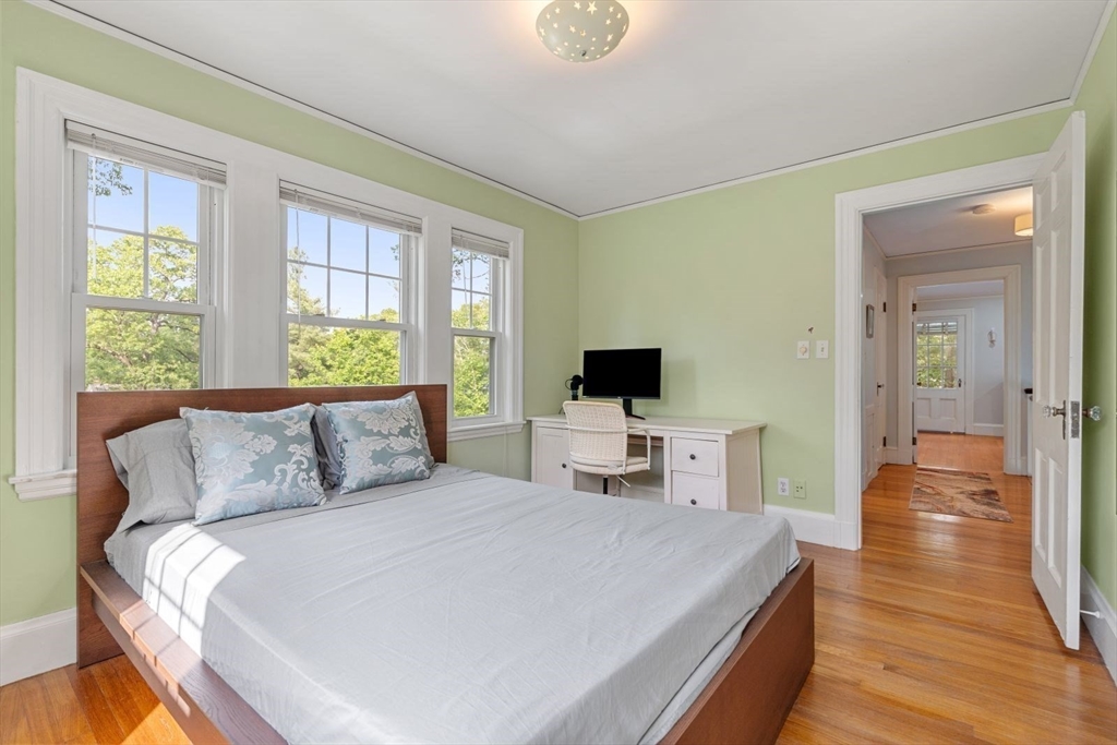 77 Meriam Street Lexington, MA 02420 - Photo 24 of 35 a bedroom with a bed and a flat screen tv