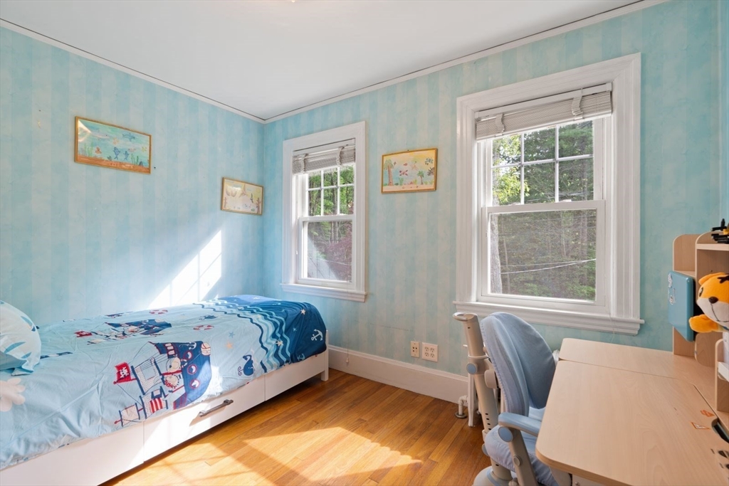 77 Meriam Street Lexington, MA 02420 - Photo 25 of 35 a bedroom with a bed and window