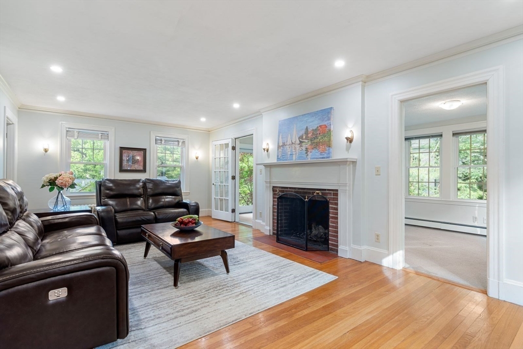 77 Meriam Street Lexington, MA 02420 - Photo 7 of 35 a living room with furniture and a fireplace
