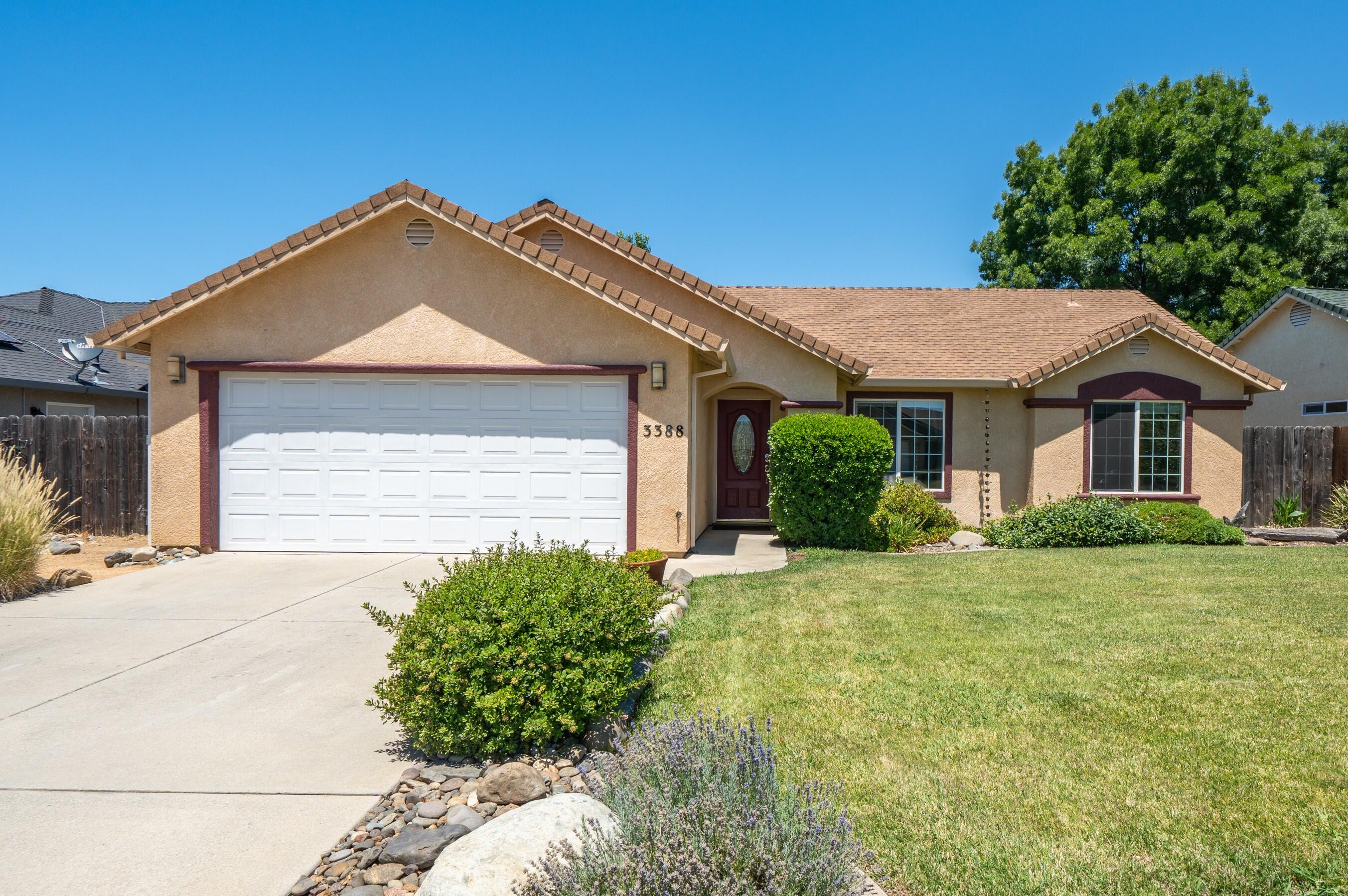 3388 Oak Street Anderson, CA 96007 - Photo 1 of 36 a front view of a house with a yard and garage