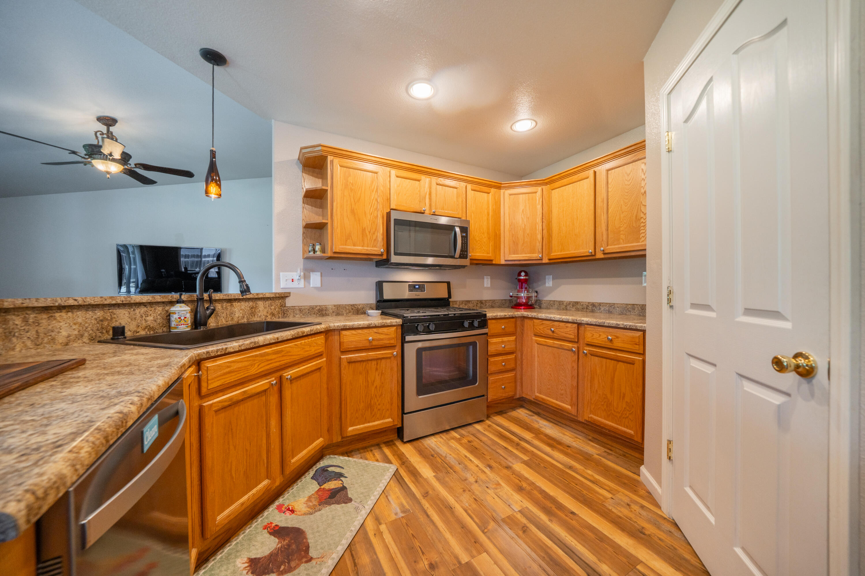 3388 Oak Street Anderson, CA 96007 - Photo 11 of 36 a kitchen with granite countertop a sink cabinets and stainless steel appliances