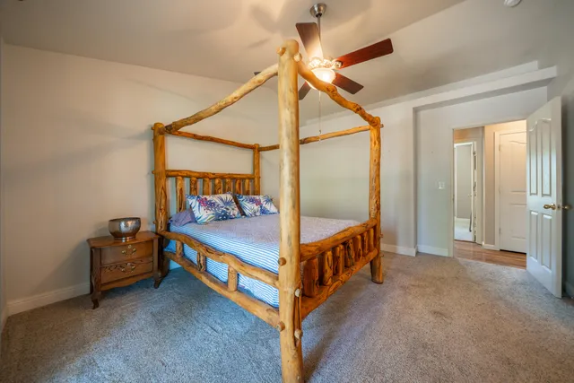 a bathroom with a granite countertop toilet sink and mirror