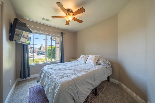 a bedroom with a bed and a flat screen tv