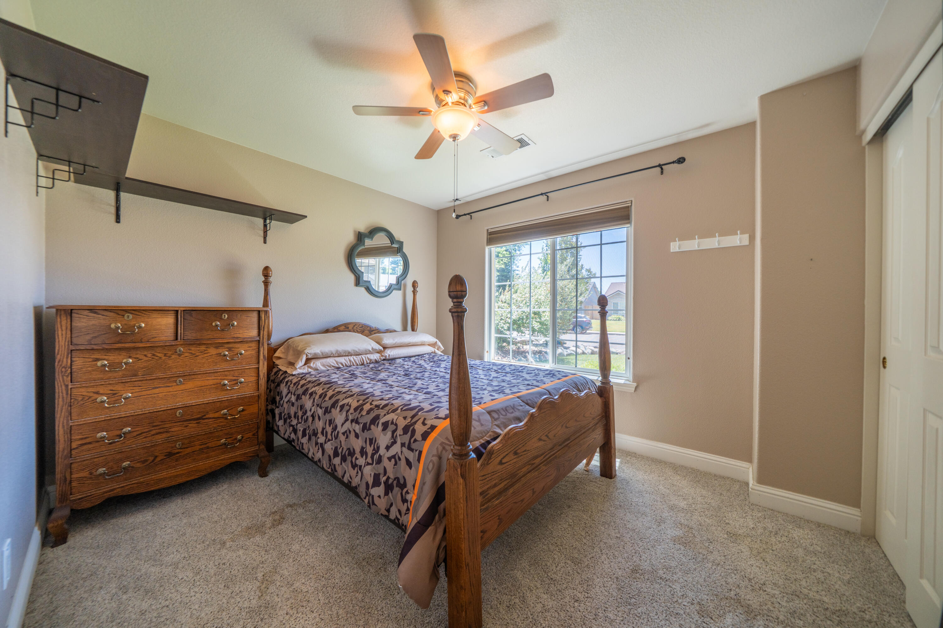 3388 Oak Street Anderson, CA 96007 - Photo 20 of 36 a bedroom with a bed and a ceiling fan