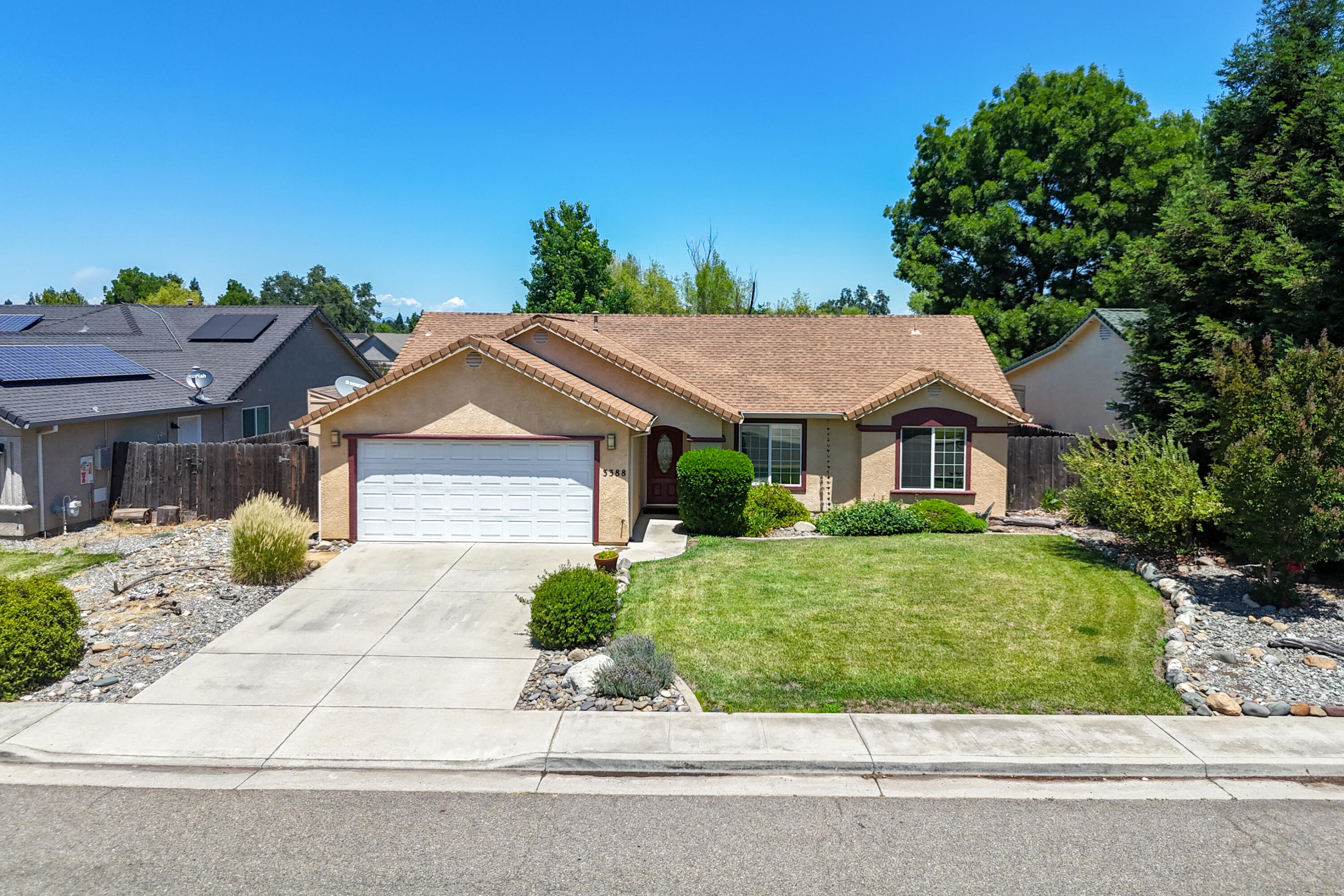 3388 Oak Street Anderson, CA 96007 - Photo 33 of 36 a front view of a house with a yard and potted plants
