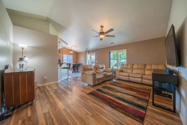 a living room with furniture and a chandelier