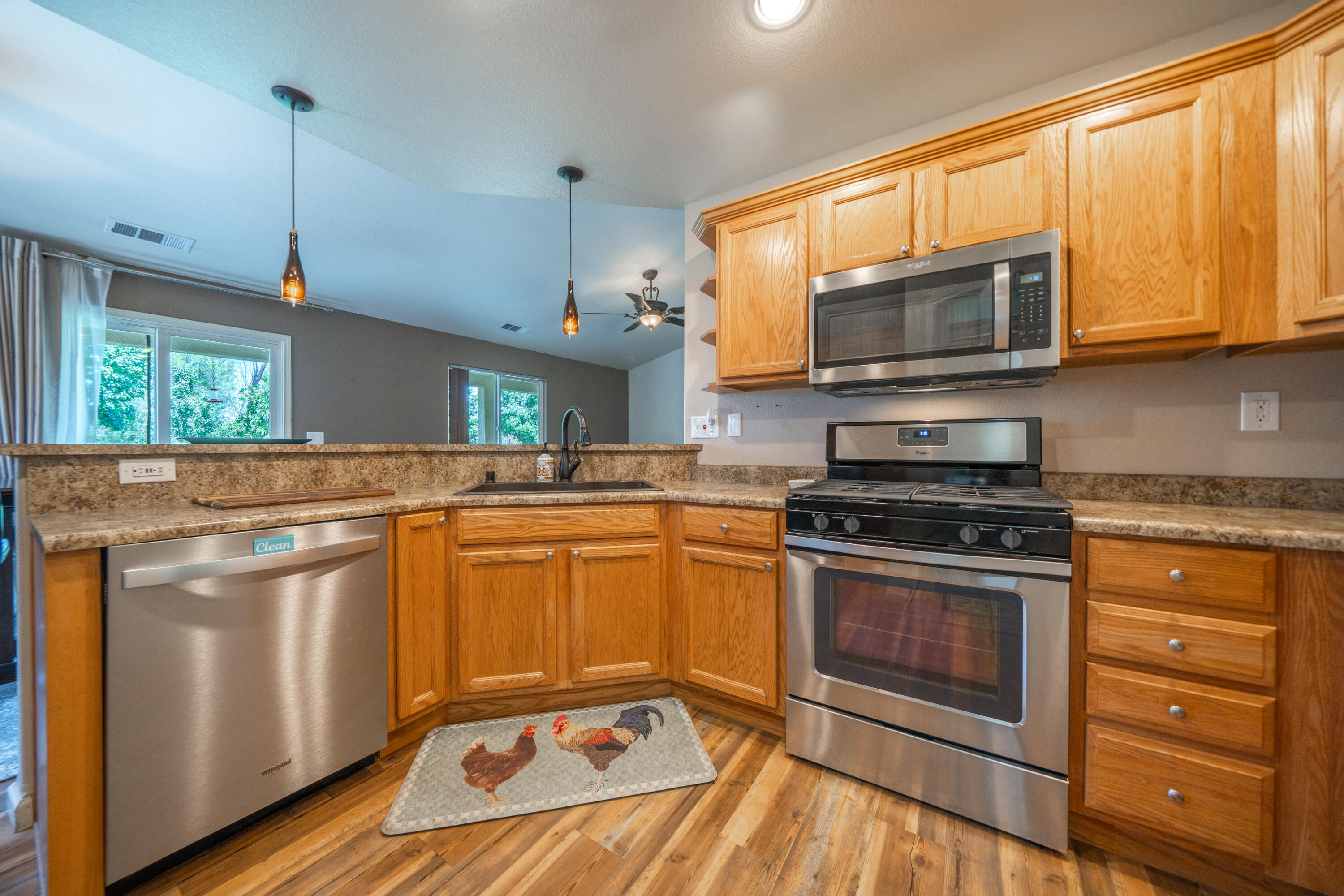 3388 Oak Street Anderson, CA 96007 - Photo 9 of 36 a kitchen with stainless steel appliances granite countertop a stove a sink and a microwave