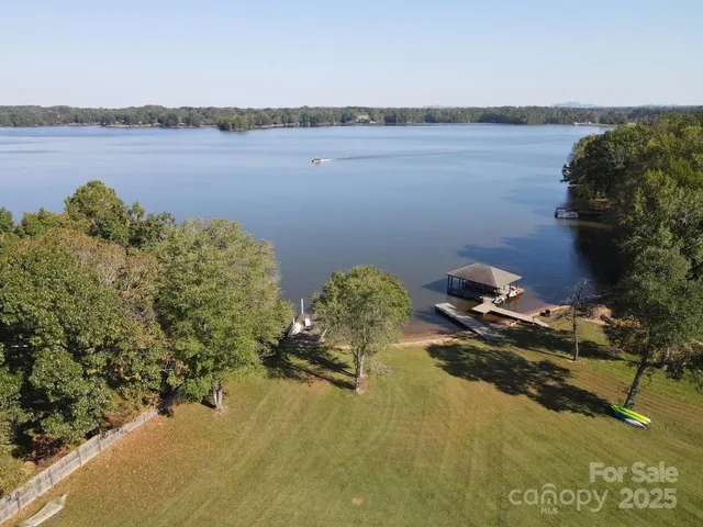 an aerial view of a house with yard swimming pool and outdoor seating