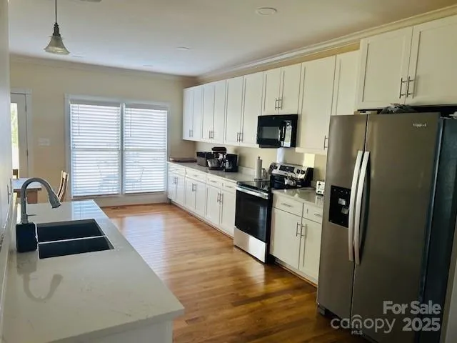 a kitchen with sink and cabinets