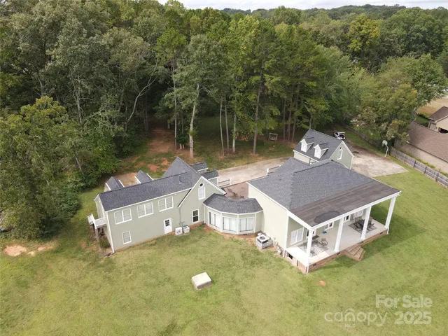aerial view of a house with a yard