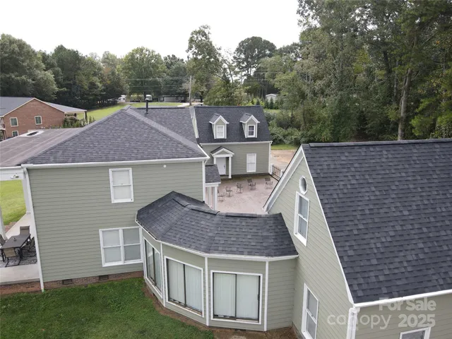 a aerial view of a house with a yard