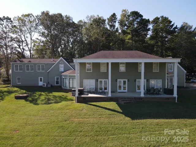 a view of a house with swimming pool and sitting area