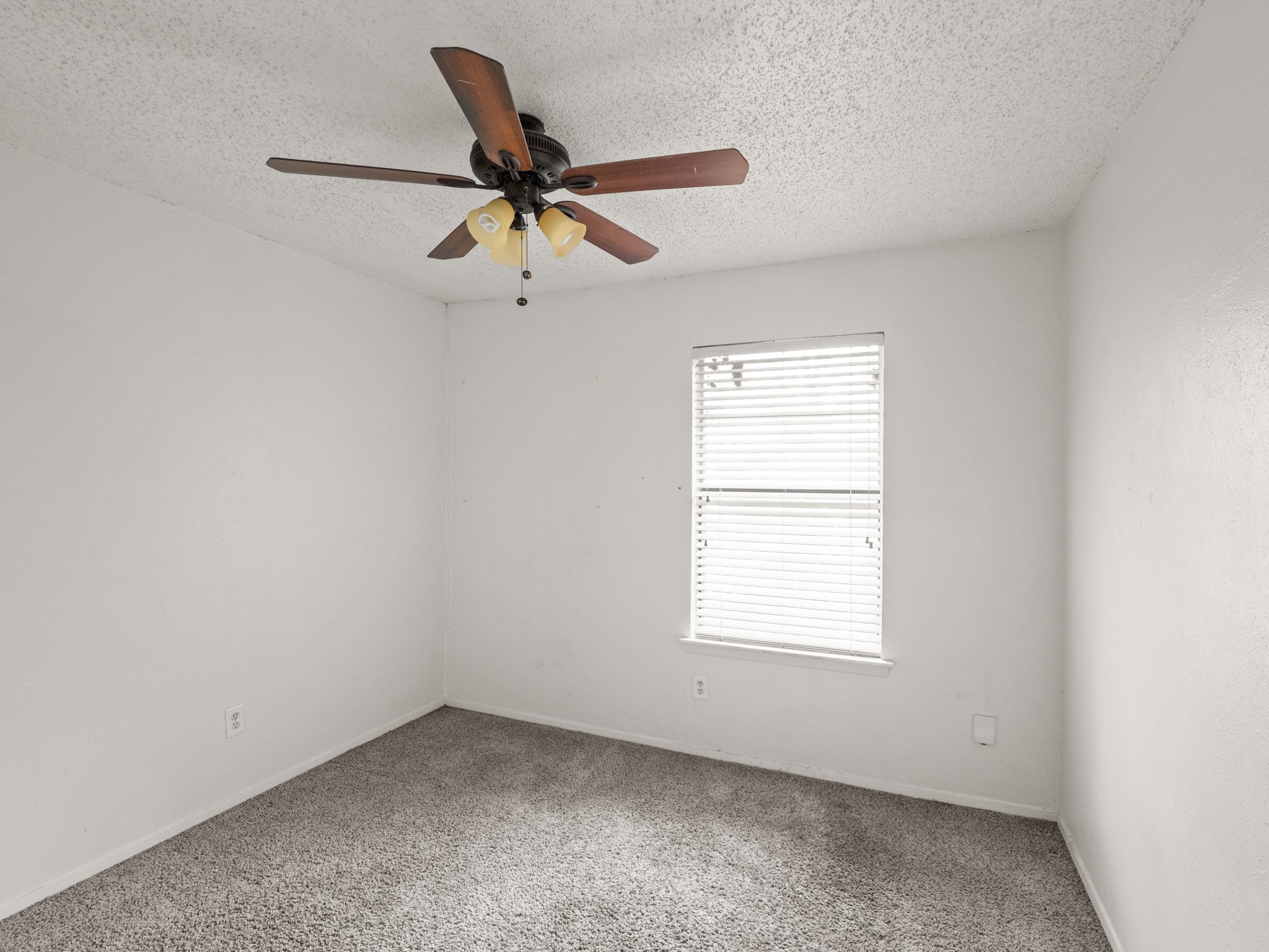 3507 Alpine Circle, Unit 3 Austin, TX 78704 - Photo 6 of 9 an empty room with a window and a fan