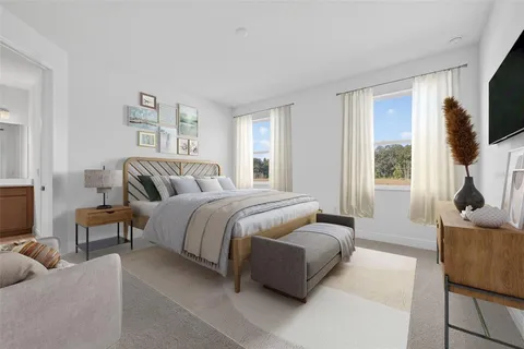 a bedroom with a bed and a flat screen television