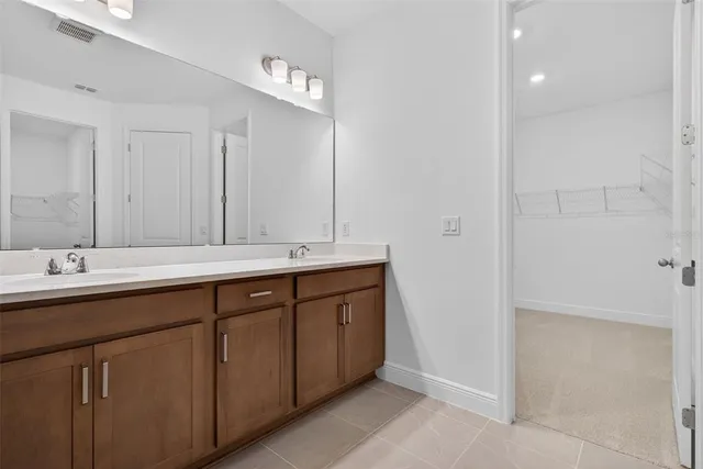 a bathroom with double sink and a mirror
