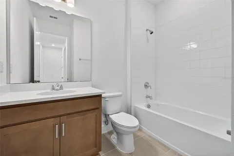 a view of an empty room with closet and a window