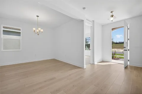 a view of a livingroom with wooden floor and a window