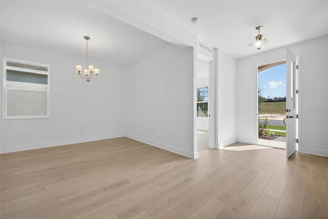 a view of a livingroom with wooden floor and a window