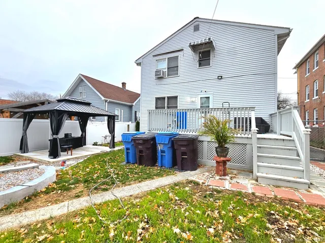 a front view of house with yard outdoor seating and barbeque oven