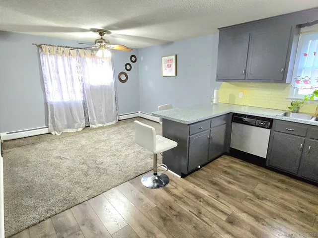 a kitchen with a sink window and cabinets