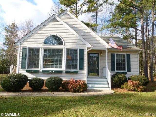 a front view of a house with a yard and outdoor seating
