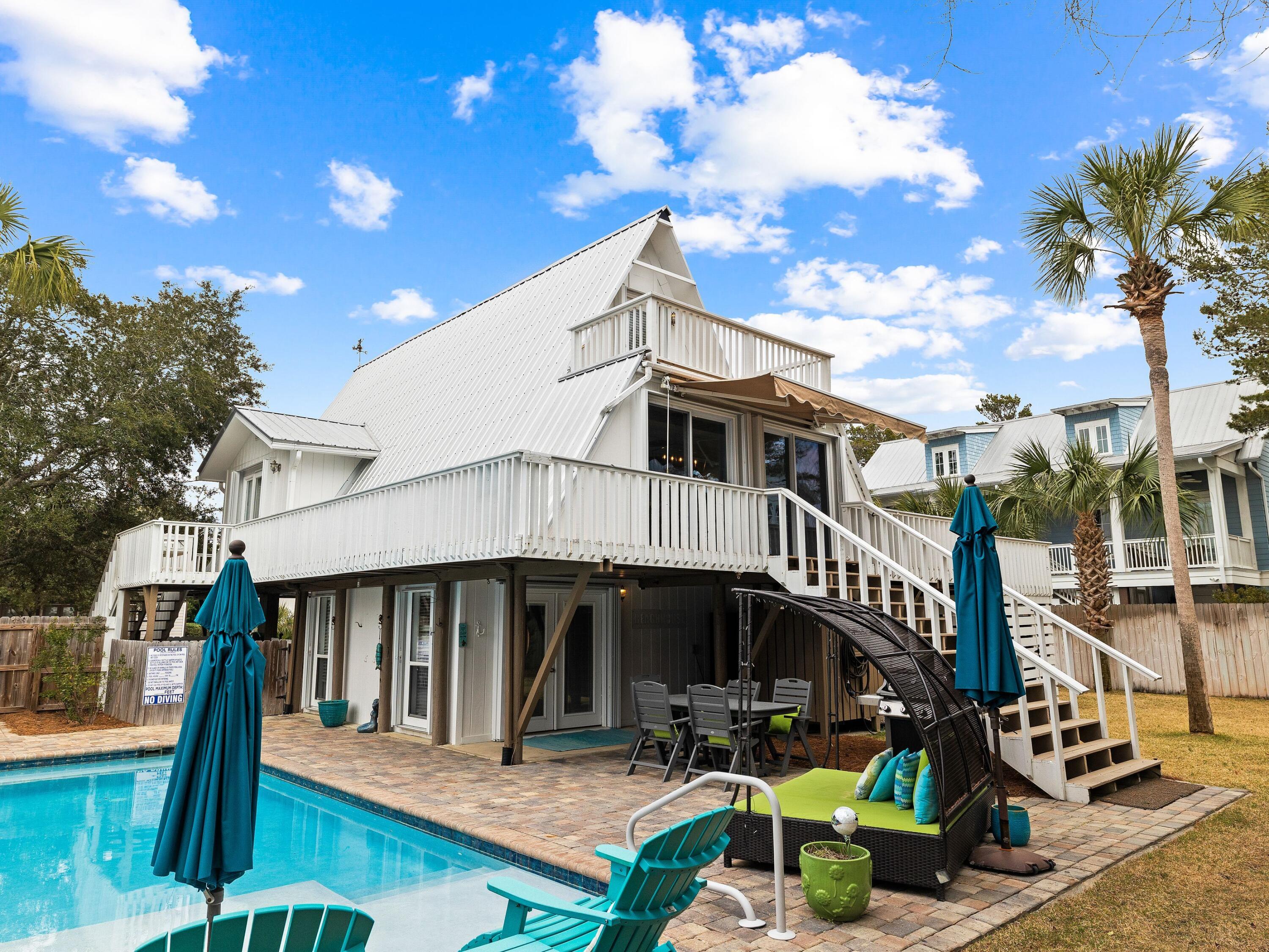124 Buddy Street Santa Rosa Beach, FL 32459 - Photo 23 of 42 a front view of a house with swimming pool and furniture