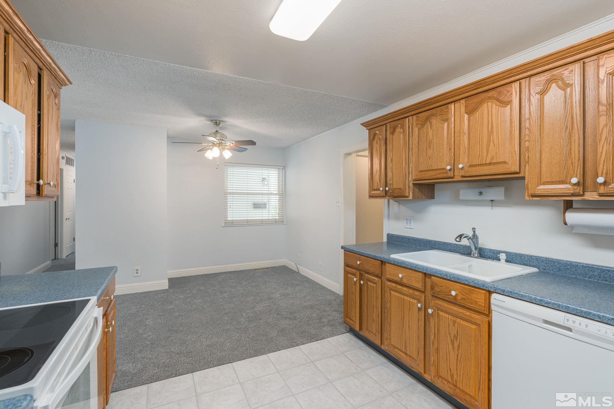1065 Beldon Way Reno, NV 89503 - Photo 11 of 35 a kitchen with a sink stove and cabinets