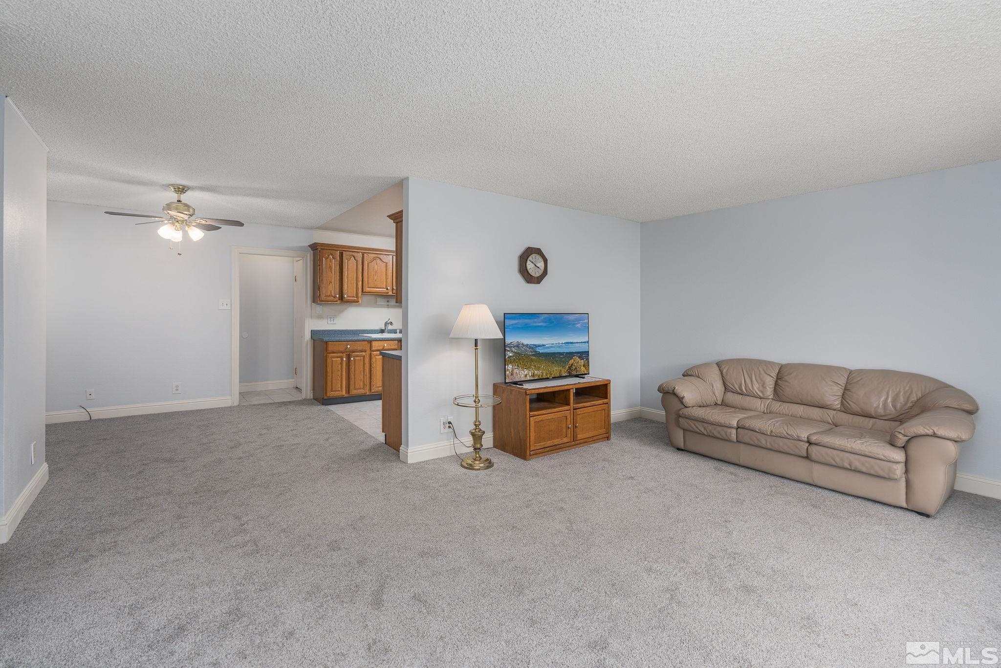 1065 Beldon Way Reno, NV 89503 - Photo 12 of 35 a living room with furniture and a kitchen