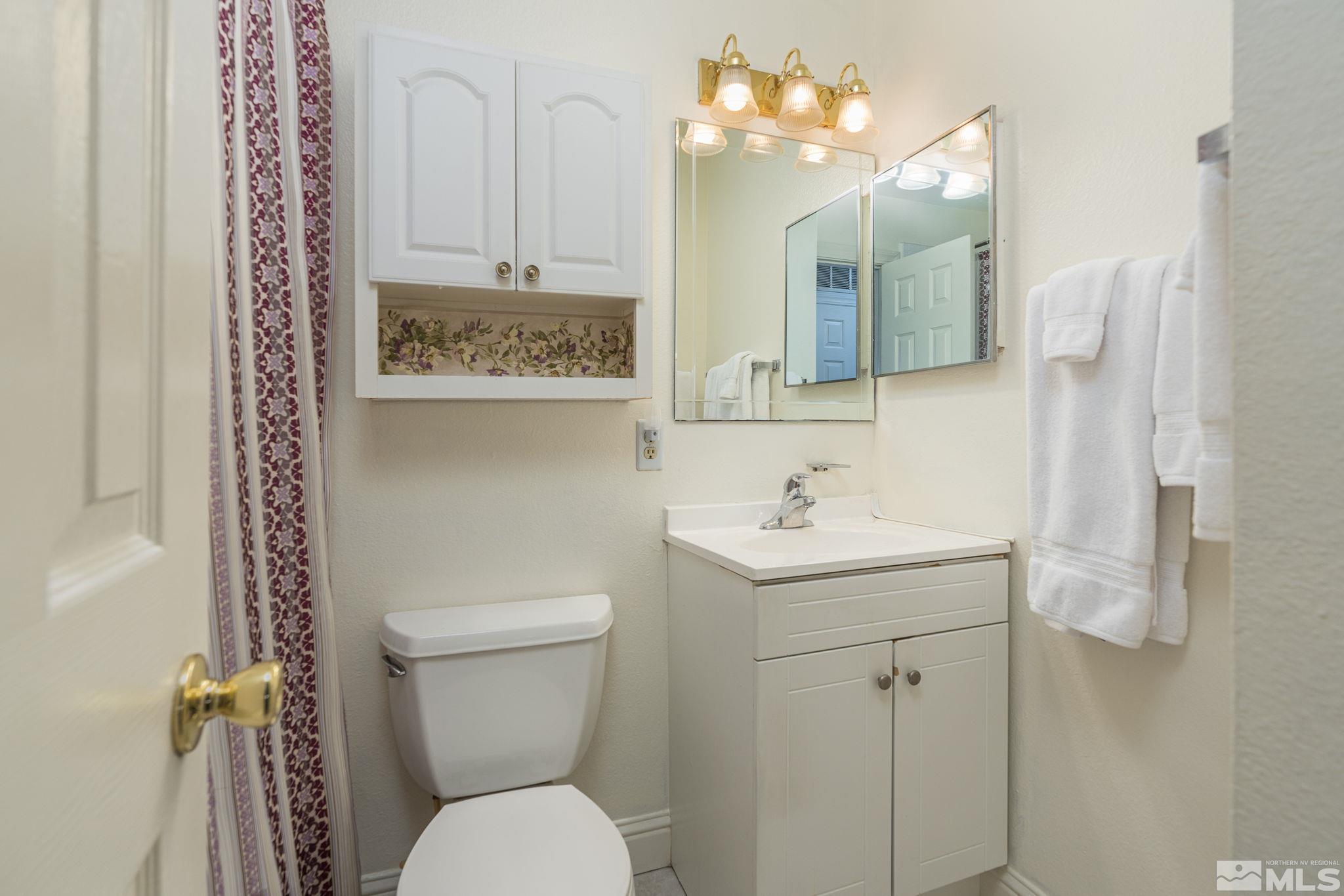 1065 Beldon Way Reno, NV 89503 - Photo 24 of 35 a bathroom with a toilet sink and mirror