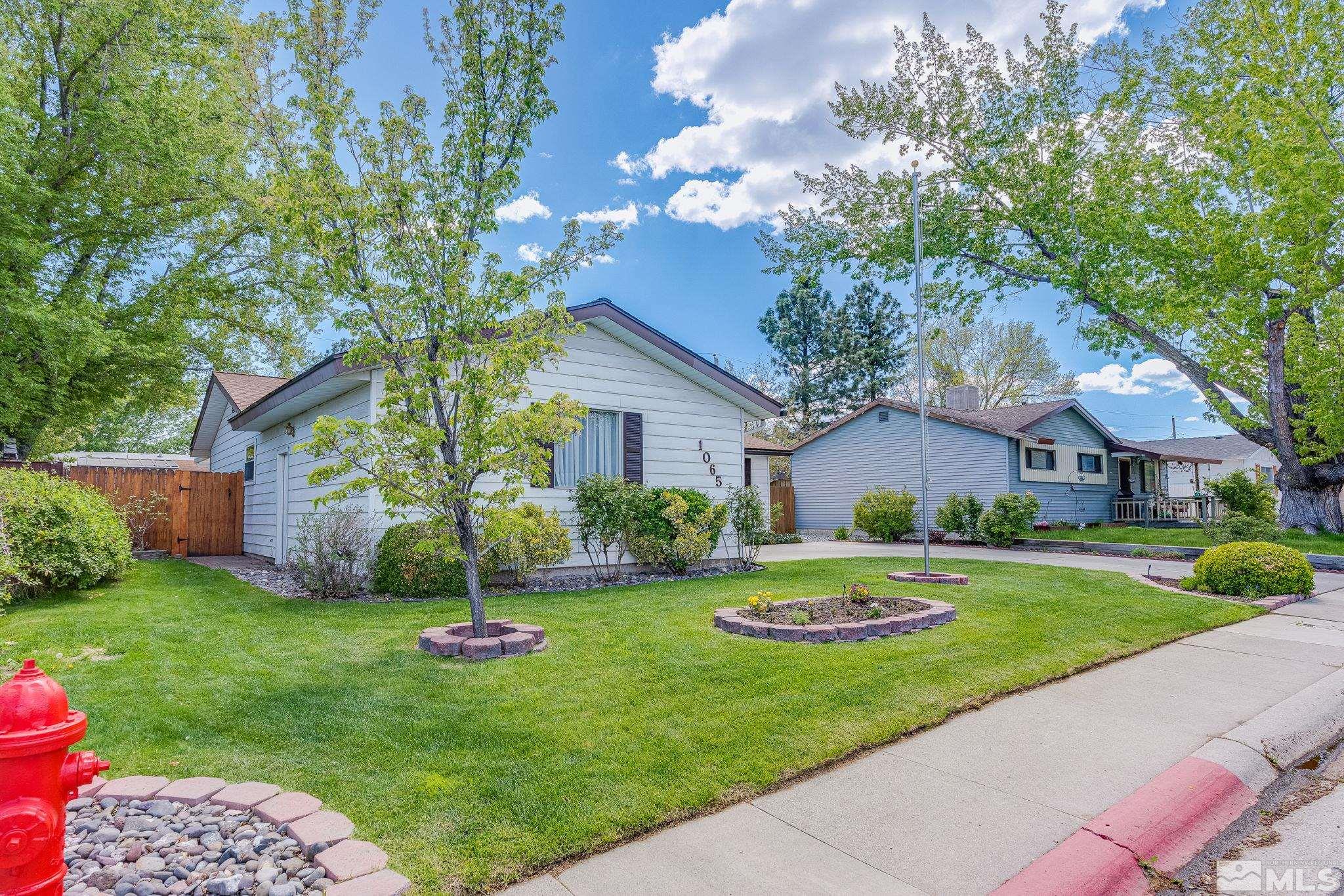 1065 Beldon Way Reno, NV 89503 - Photo 3 of 35 a front view of a house with a yard and garage