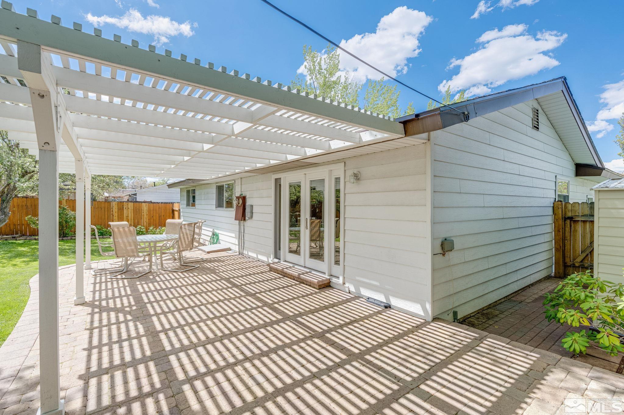 1065 Beldon Way Reno, NV 89503 - Photo 33 of 35 a bedroom with a bed and a chandelier