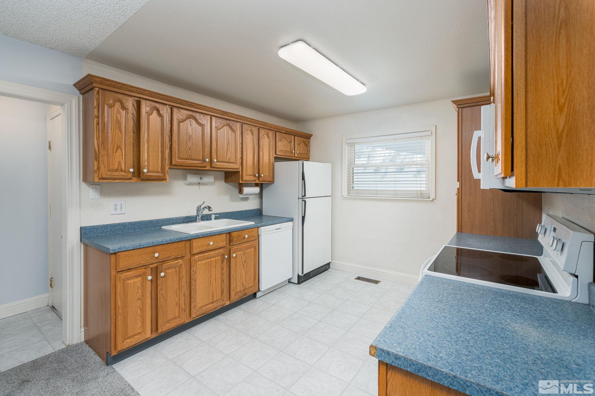 1065 Beldon Way Reno, NV 89503 - Photo 7 of 35 a kitchen with stainless steel appliances granite countertop a sink stove and refrigerator