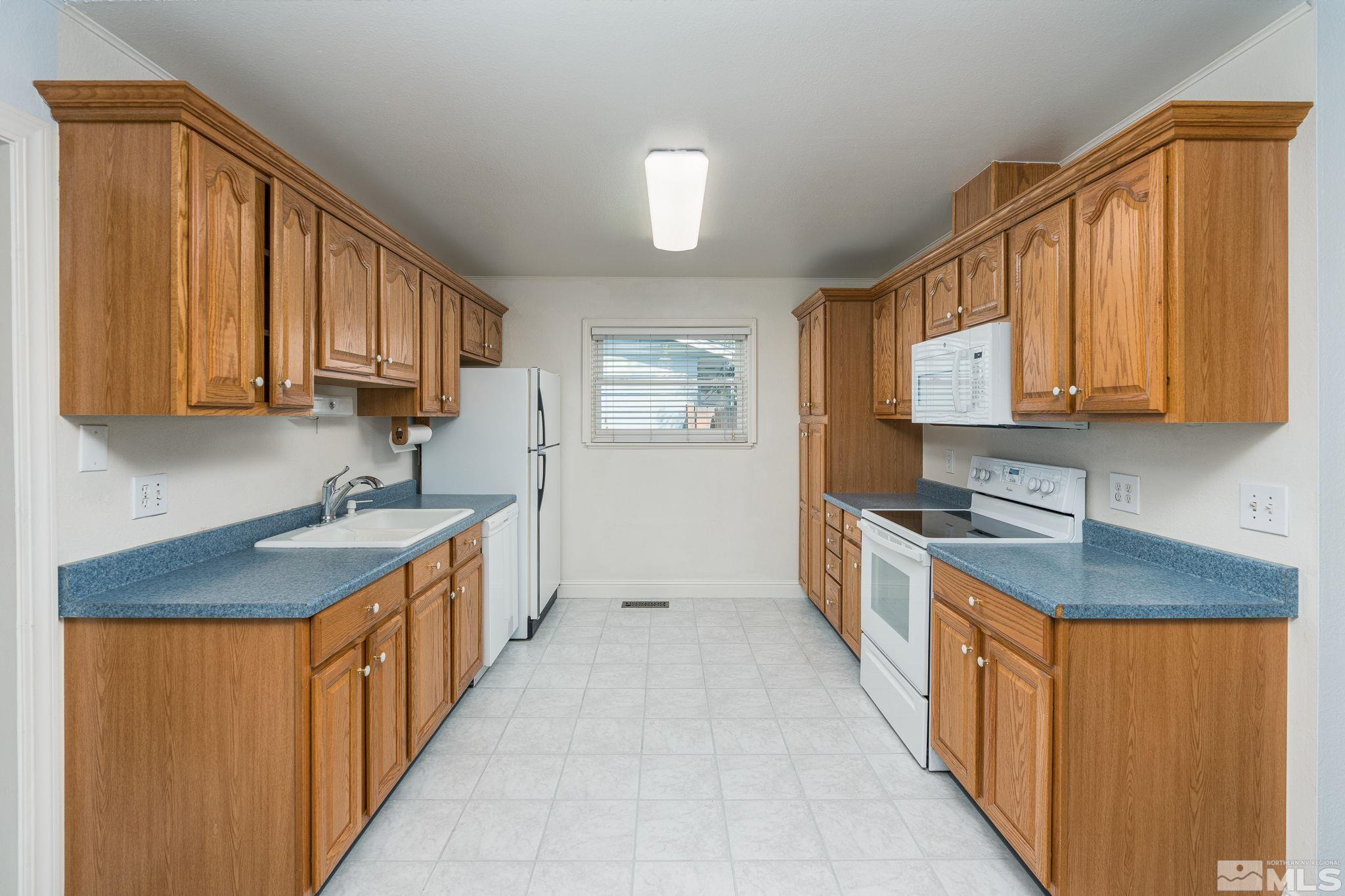 1065 Beldon Way Reno, NV 89503 - Photo 8 of 35 a kitchen with stainless steel appliances granite countertop a stove a sink dishwasher and a refrigerator