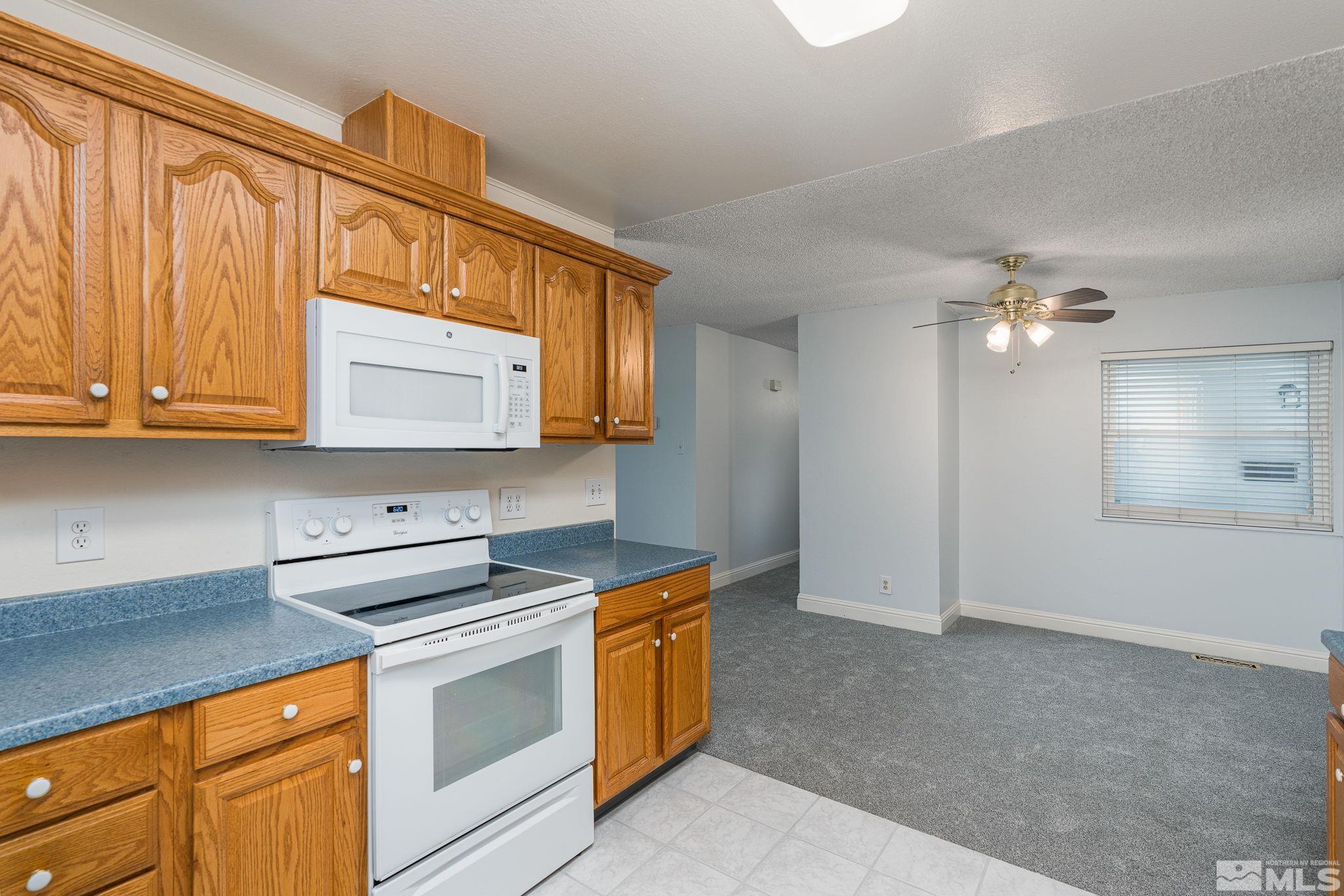 1065 Beldon Way Reno, NV 89503 - Photo 10 of 35 a kitchen with stainless steel appliances granite countertop a sink a stove a microwave and cabinets