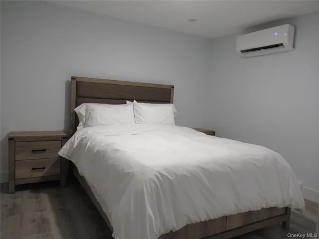 a large bed sitting in a bedroom next to a window
