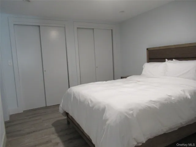 a large bed sitting in a bedroom next to a cabinet