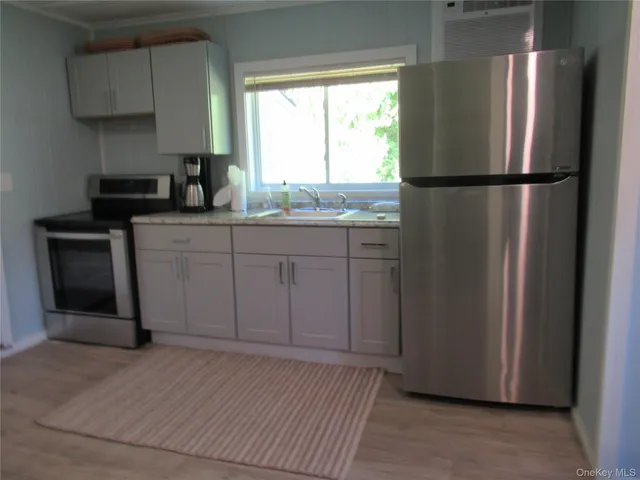 a kitchen with a refrigerator and window