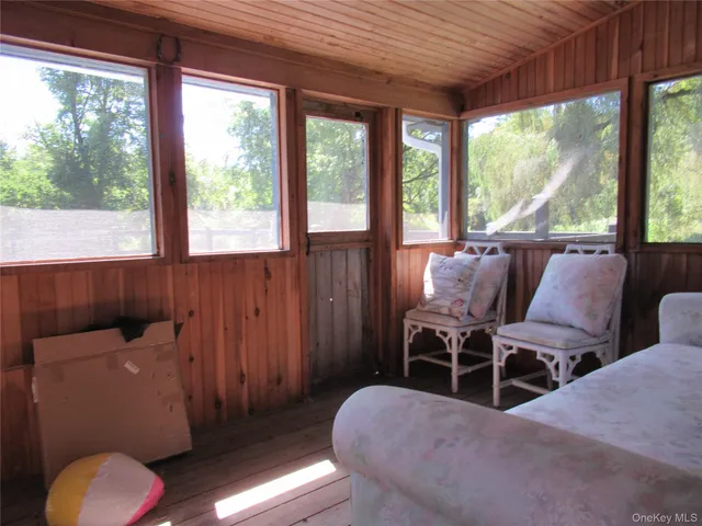 a balcony with furniture and wooden floor