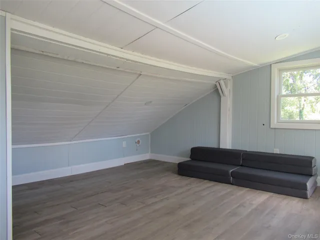 a living room with hard wood floors and a couch