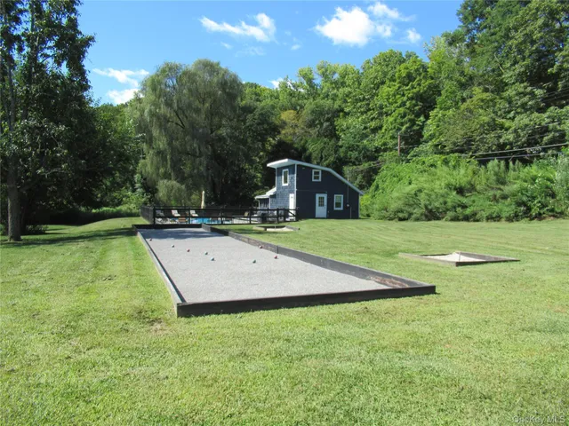 a view of a backyard with swimming pool