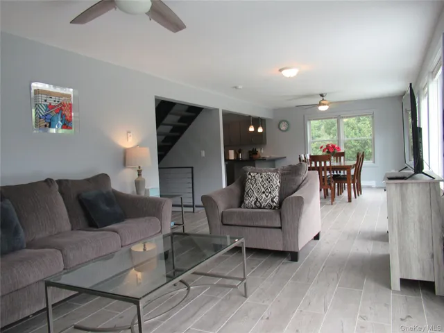 a living room with furniture and wooden floors