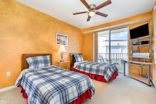 a bedroom with bed and a large window