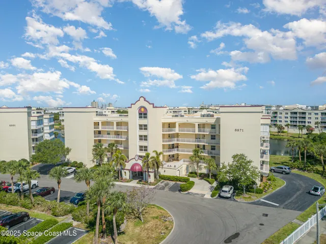 a view of a patio with plants and a fountain