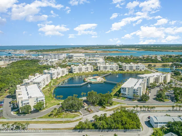 an aerial view of residential building and lake