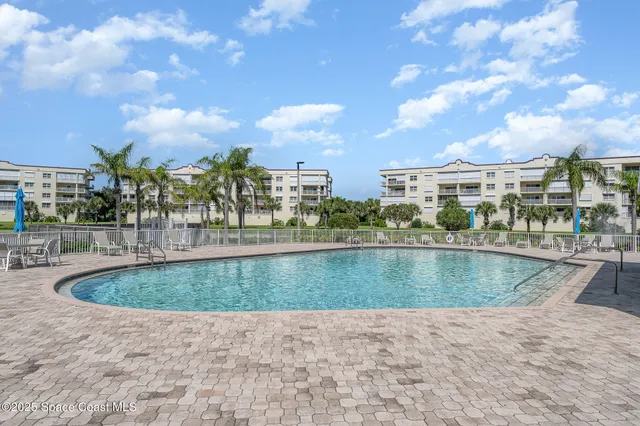 a view of house with swimming pool and green space