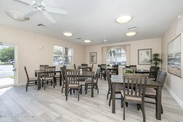 a kitchen with stainless steel appliances white cabinets a sink a stove a refrigerator and island