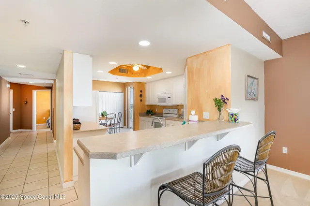 a kitchen with a sink and chairs