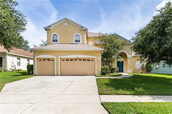 a front view of a house with a yard and garage