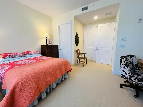 a bed room with a bed and a chair